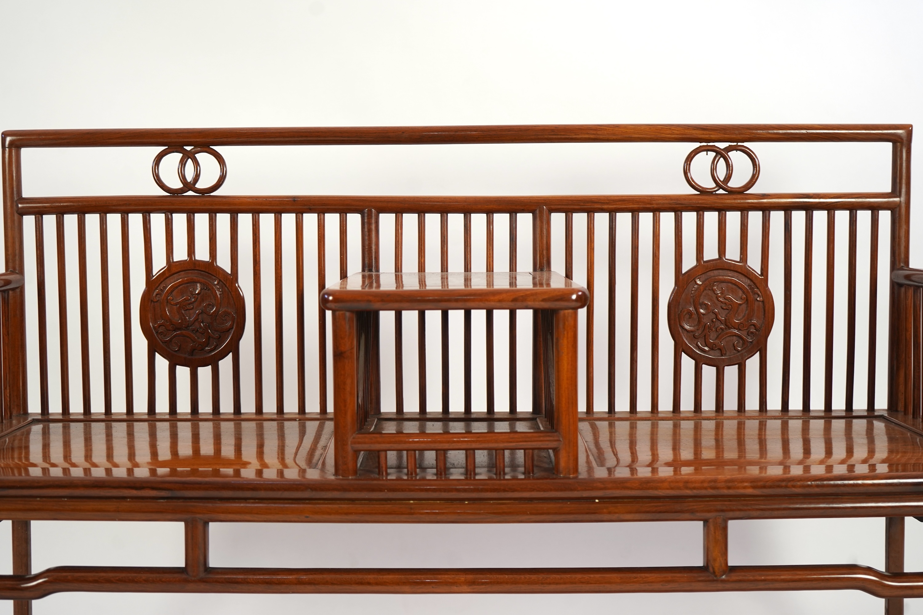 A Chinese hardwood and burrwood inset spindle-back bench, early 20th century